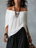 Ensemble composé d'un haut blanc à épaules dénudées et d'un pantalon ample style lanterne