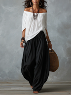 Ensemble composé d'un haut blanc à épaules dénudées et d'un pantalon ample style lanterne