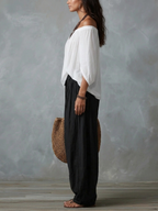 Ensemble composé d'un haut blanc à épaules dénudées et d'un pantalon ample style lanterne